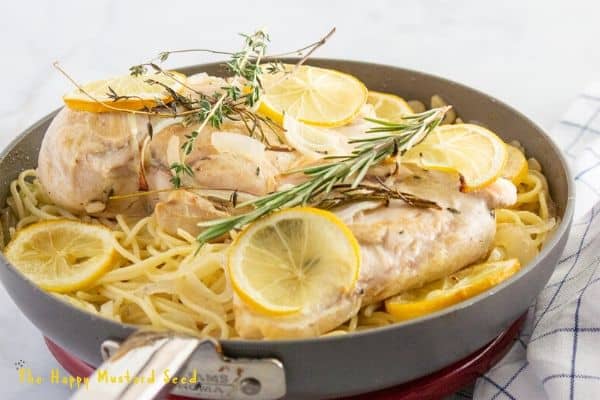 lemon and chicken with thyme in pan with pasta