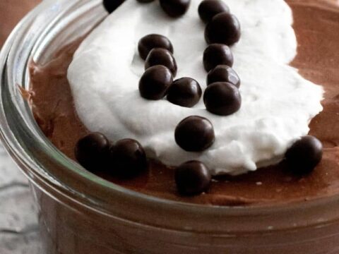 close image of chocolate cheesecake mousse with whipped cream