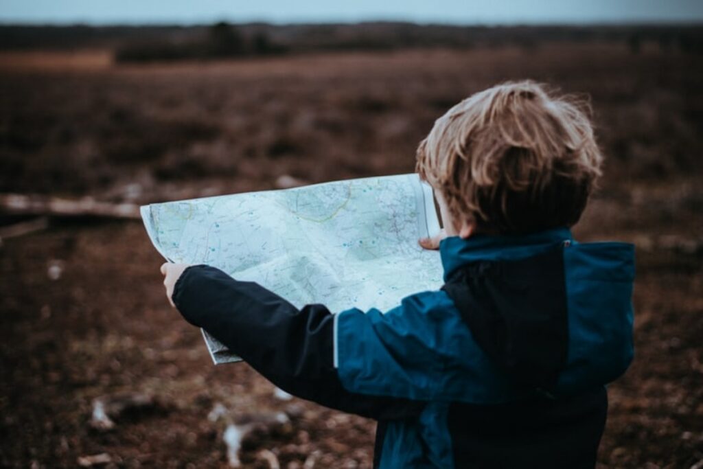 kid holding map