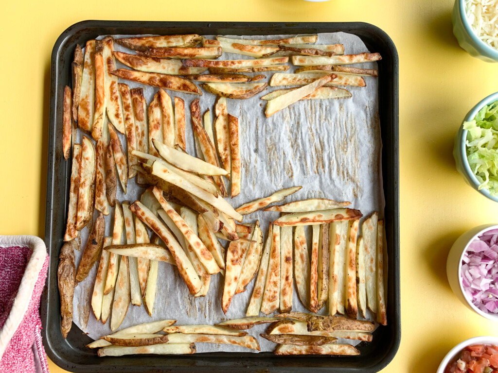 top view of sliced potatoes on baking sheet for air fryer fries