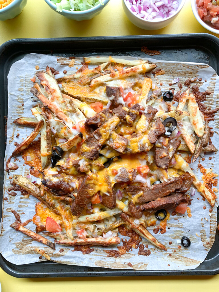 top view of carne asada fries on baking sheet