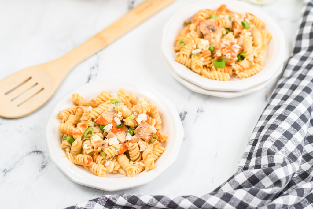 two plates of buffalo chicken pasta salaed