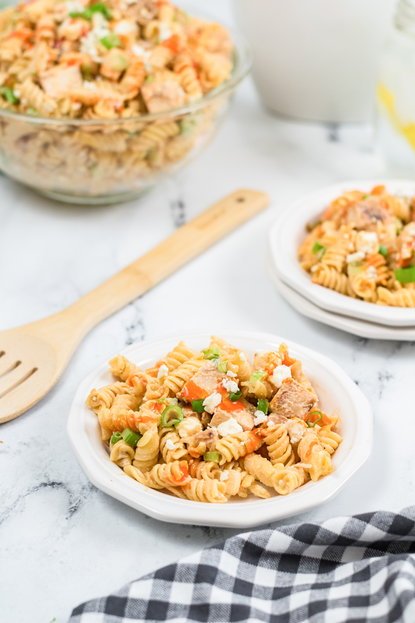 one plate of buffalo chicken pasta salad with wooden spoon 